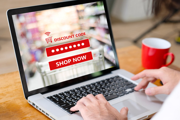 E-coupon, Grocery shopping online, Woman hand using laptop computer entering the discount coupon code on screen, online shopping sale, digital marketing, retail business and technology, e commerce promotion concept